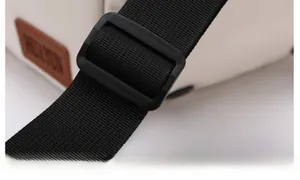 Detail of adjustable nylon shoulder strap and plastic buckle on Oxford travel bag