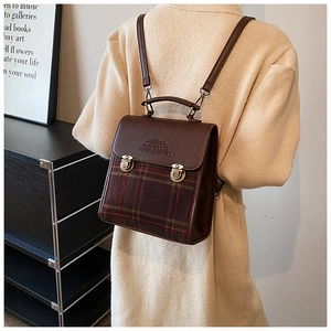 British style vintage plaid backpack in brown leather with metal buckles on model