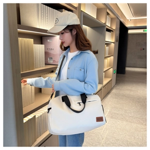 Detailed shot of pearl white Oxford cloth travel bag with premium fabric straps