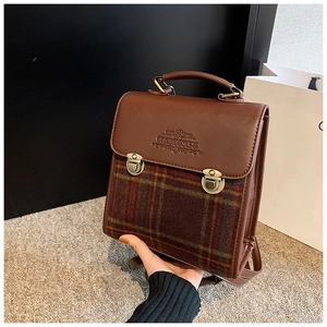 Detail of vintage brown PU leather and plaid stitching on women’s versatile backpack