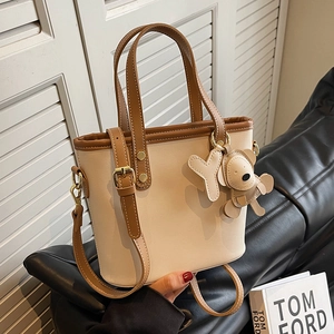 Minimalist beige and brown bucket bag with adjustable strap and cute bear charm pendant