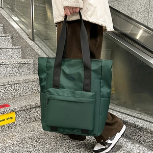 Deep green nylon tote bag with large zipper pocket for commuting and daily school use