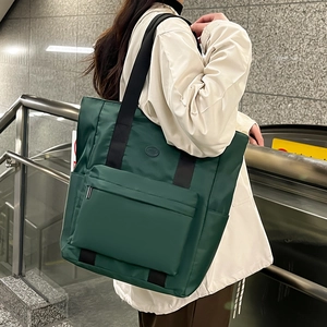 Large dark green nylon tote bag with zipper pocket and black shoulder straps