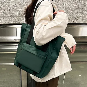 Dark green nylon tote bag with large zipper pocket for commuting and daily wear