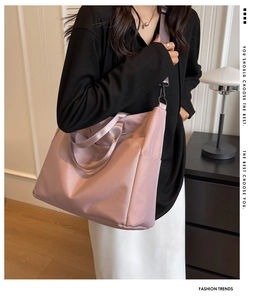 Detail of pink nylon tote bag with adjustable shoulder strap and side pocket