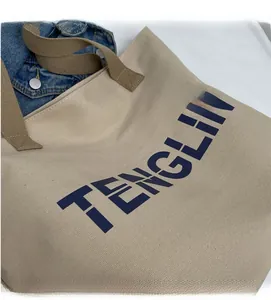 Detailed shot of beige canvas tote bag with TENGLI lettering and durable handles