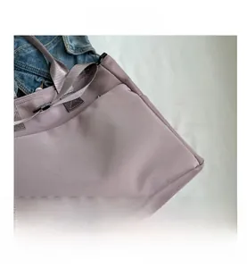 Close-up of lilac nylon tote bag showing durable fabric texture and reinforced stitching