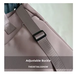 Detail of adjustable black buckle and high-density nylon fabric on the purple tote bag