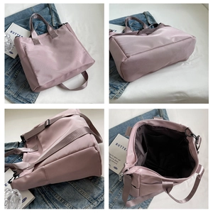 Detail showing the large capacity nylon tote with functional inner pockets and strap hooks
