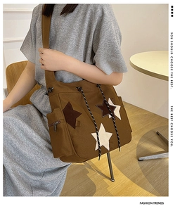 Detail of vintage canvas tote with star patches, drawstring closure and side pocket