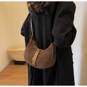 Close-up of the vintage brown suede half-moon shoulder bag with gold metal hardware