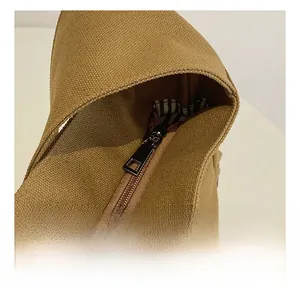 Close-up of smooth metal zipper and striped lining on a vintage canvas tote bag