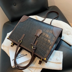 Retro large capacity tote bag in black crocodile embossed and brown leather with metal buckles