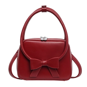 Trendy red handbag for women featuring a large bow and silver double zippers