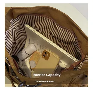 Detailed view of the brown canvas tote interior with striped lining and pockets