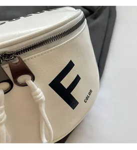 Close-up of creamy white saddle bag showing lychee grain texture and F COLOR logo
