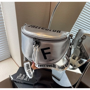 Close-up of silver textured leather saddle bag with contrast wide letter strap