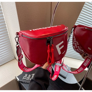 Detailed mirror view of red leather saddle bag with white lettering and wide strap