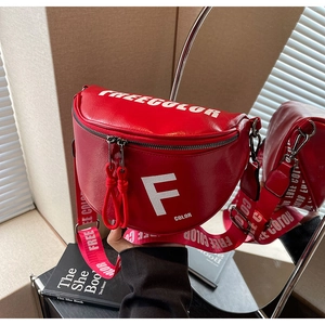 Close-up of red semicircular crossbody bag featuring white F letter print and wide strap