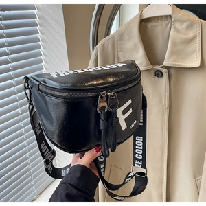 Detail of black half-moon crossbody bag with bold white lettering and adjustable wide strap