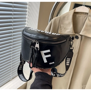 Detail of black crossbody bag with wide shoulder strap and white FREE COLOR typography