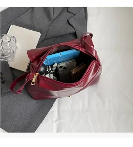 Deep red leather tote bag interior showing large capacity for tablet and daily items