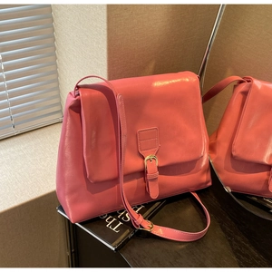 Detail shot of the pink PU leather tote bag featuring a gold buckle and flap closure