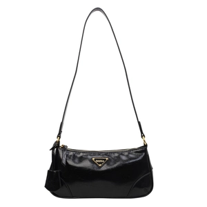Minimalist black patent leather underarm bag with gold triangle logo and vintage strap