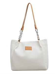 White quilted tote bag with brown leather straps and metal chains for women's daily commute
