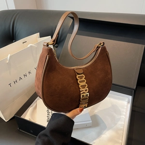 Retro brown suede half-moon shoulder bag with gold hardware shown in premium gift box