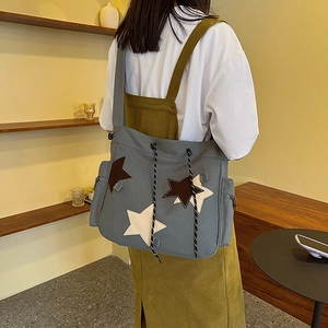 Retro grey canvas tote bag with star embroidery for women in a cozy home setting