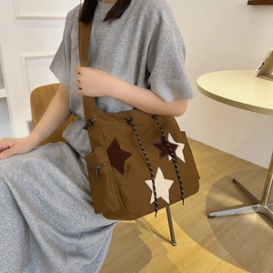 Retro canvas tote bag in brown with star patches and large capacity for daily commute