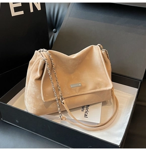 Beige suede tote bag with silver metal plate in a premium black gift box packaging