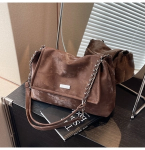 Detailed close-up of retro brown chain bag with matte texture and silver metallic hardware