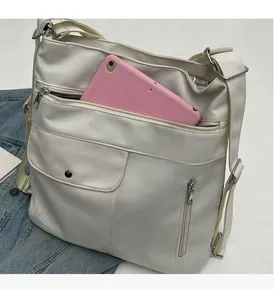 Top view of white multi-pocket tote bag with tablet showing large storage capacity