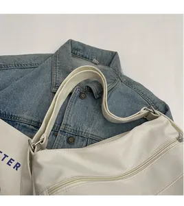 Detail of adjustable shoulder strap and smooth faux leather texture on the beige tote bag