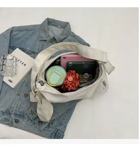 Detailed interior of a white tote bag showing pockets with tablet and daily essentials