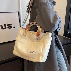 Off-white canvas tote bag with geometric print wide strap for shoulder and hand carry