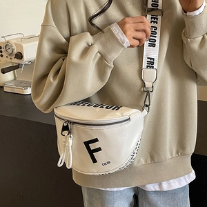 White minimalist crescent saddle bag with wide shoulder strap and textured leather finish