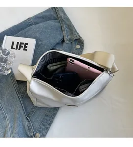 Internal view of a spacious nylon bucket bag showing striped lining and compartment capacity