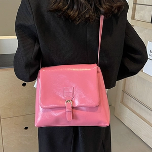 Pink patent leather tote bag with buckle flap for stylish women commute and shoulder wear