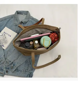 Detailed interior view of a large khaki canvas tote bag showing its spacious capacity
