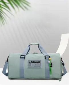 Detailed close-up of a mint green travel bag with blue straps and smiley face charm
