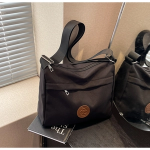 2024 minimalist black crossbody bag in durable nylon with round leather logo and wide strap