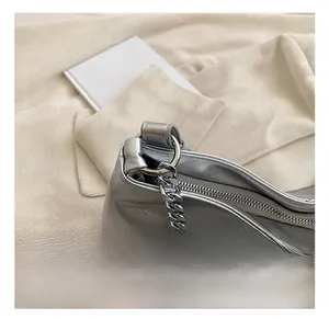 Close-up of premium silver metallic tote featuring high-quality chunky metal chain and zipper