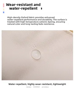 Detailed view of beige waterproof Oxford cloth with water droplets showing fabric texture
