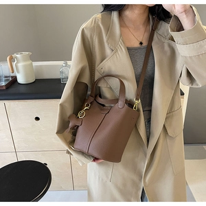 Brown litchi grain leather bucket bag with cute elephant charm and dual straps