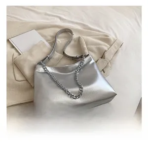 Silver metallic tote bag with unique pleated texture and decorative chunky chain strap