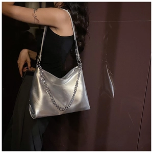 Detail of silver metallic tote bag featuring wrinkled leather and chunky chain strap