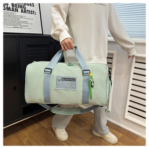 Detailed view of mint green waterproof nylon travel bag with durable woven handles